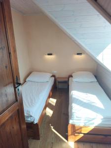 two beds in a room with a staircase at Gama Spa in Władysławowo