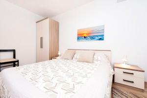 Postel nebo postele na pokoji v ubytování Apartments Maxi