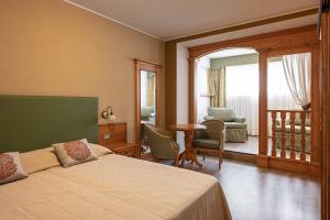 Rúm í herbergi á Hotel Pangrazzi - 3 stelle superior