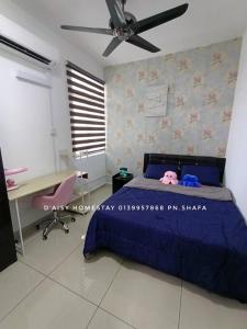 a bedroom with a blue bed and a desk at D'Aisy Homestay Sepang Klia Nilai in Sepang