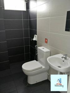 a bathroom with a toilet and a sink at D'Aisy Homestay Sepang Klia Nilai in Sepang