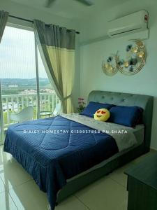 a bedroom with a blue bed and a window at D'Aisy Homestay Sepang Klia Nilai in Sepang