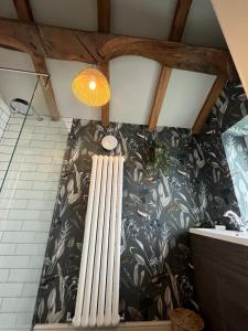 a bathroom with a large radiator on the wall at Saltonstall Airbnb in Halifax