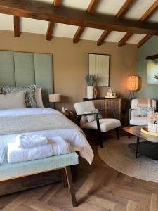 a bedroom with a bed and a chair and a table at Saltonstall Airbnb in Halifax