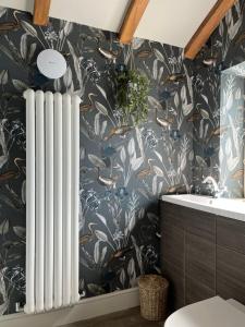 a bathroom with a radiator next to a sink at Saltonstall Airbnb in Halifax