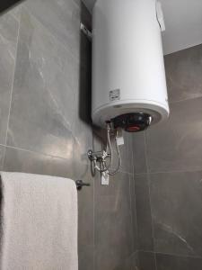 a white light in a bathroom with a towel at Klea Rooms in Velipojë +47 photos