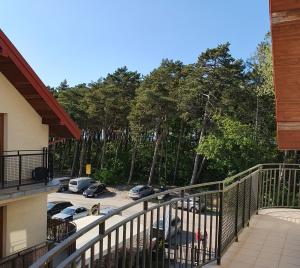 a balcony with a view of a parking lot at APARTAMENT QUEEN KARWIA in Karwia