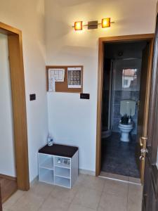 a bathroom with a toilet and a door to a room at Appartement Sonia in Fažana