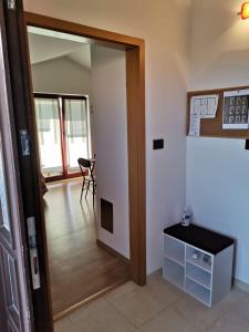 a hallway with a door open to a room with a table at Appartement Sonia in Fažana