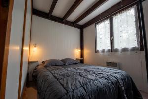 a bedroom with a bed and a large window at Camping les falaises de Toussaint in Toussaint