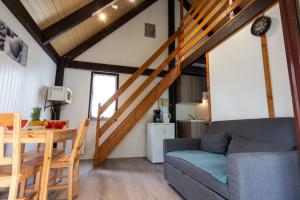 a living room with a couch and a table at Camping les falaises de Toussaint in Toussaint