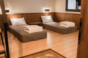 Zimmer mit 2 Betten und einem Tisch in der Unterkunft 秀川居 Xiuchuanju in Bezirk Sanxia