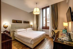 Postel nebo postele na pokoji v ubytování Hotel Croce Di Malta