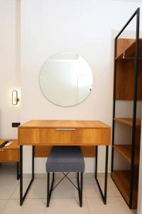 a desk with a mirror and a chair at Maor Hotel in Vlorë