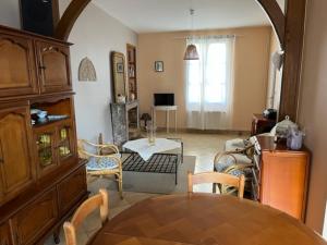 a living room with a table and chairs at Chambre Le Mans 24 heures in Le Mans