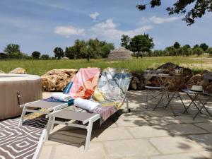 a chair with a blanket on it sitting on a patio at Terre di Sveva in Castel del Monte