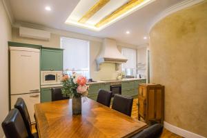 a kitchen with a wooden table and some chairs at Kouketa Luxury in Corfu Town
