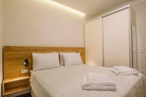 a bedroom with a bed with two towels on it at Kouketa Luxury in Corfu Town