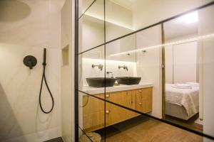 a bathroom with two sinks and a shower at Kouketa Luxury in Corfu Town +5 photos