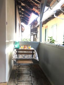 a small table with chairs in a small balcony at Mirabel in Beaulieu-sur-Dordogne