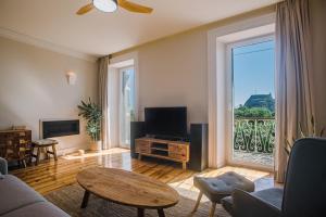 a living room with a large window and a television at Kouketa Luxury in Corfu Town