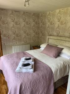 a bedroom with a bed with a tray on it at Clematis cabin in Hereford
