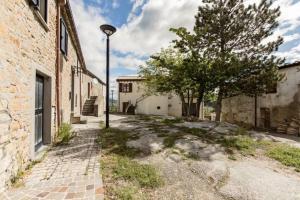 un callejón con una luz de la calle junto a un edificio en Locanda delle grotte di Onferno en Gemmano