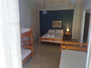 a room with two bunk beds and a lamp at Villa Artemida in Selianitika