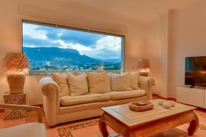 a living room with a couch and a large window at Villas Guzman - BELLISSIMA in Calpe