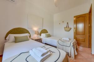 Łóżko lub łóżka w pokoju w obiekcie Villas Guzman - BELLISSIMA