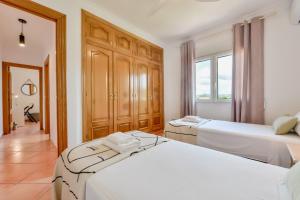 Łóżko lub łóżka w pokoju w obiekcie Villas Guzman - BELLISSIMA