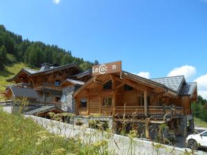 a log house with a sign on it at Les Chalets du Cocoon in La Plagne
