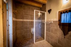 a shower with a glass door in a bathroom at Les Chalets du Cocoon in La Plagne