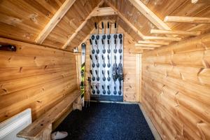 a wood paneled room with a door in a sauna at Les Chalets du Cocoon in La Plagne