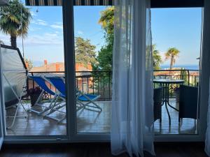 a room with a balcony with a view of the ocean at Guesthouse Villa Stanger 2 in Lovran +33 photos