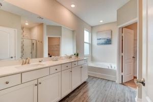 a large bathroom with two sinks and a tub at New St Augustine Waterview Home in Saint Augustine +26 photos