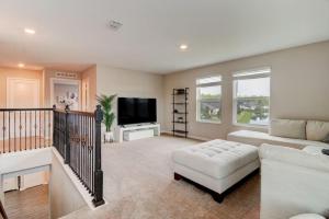 a living room with a couch and a tv at New St Augustine Waterview Home in Saint Augustine