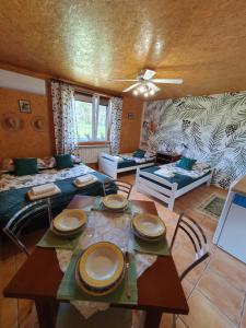 a living room with a table with plates on it at Szyszkowy Domek in Milejczyce +25 photos
