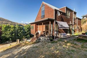 a wooden house with a porch and a picnic table at Small Wallet-Friendly Private Room in a 7 BR Shared House - The Ben's Room 6 in Queenstown