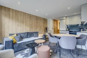 a living room with a couch and a table at Chevruls A14 in Morzine