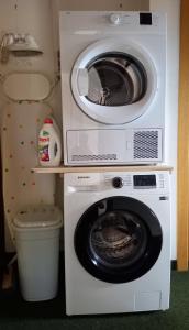- Lavadora y secadora en una habitación pequeña en Apartment Komar en Sankt Stefan an der Gail