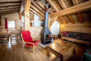 a living room with a fireplace and a dining room at Les Chalets du Cocoon in La Plagne