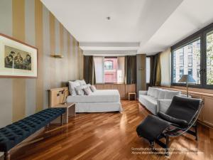 a living room with a bed and a couch at Numa Milan Camperio in Milan +40 photos