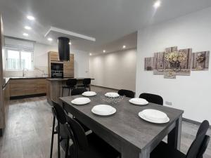 a dining room with a table and chairs in a kitchen at Zejtun 3-Bedroom Modern Apartment in Żejtun