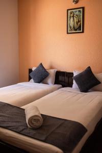 two beds in a room with two at Catalyst Suites,Domlur in Bangalore +14 photos
