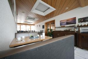 a dining room with a table and a counter at Landhotel Hirsch in Sankt Johann