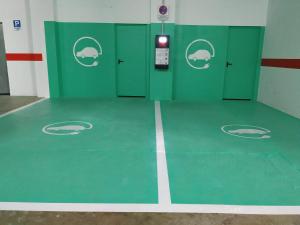 a room with green doors and a basketball court at Leo Punta Umbría in Punta Umbría