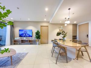 a living room with a table and a tv at The Sóng Apartments And Hotel 4 Stars in Vung Tau