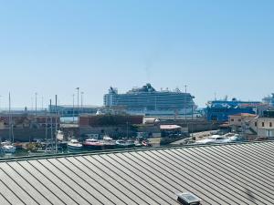 un gran crucero en un puerto con una ciudad en Be Your Home - Guest House Fuori Dal Porto, en Civitavecchia