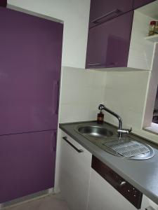 a kitchen with a sink and a faucet at Amethyst apartment in Igalo